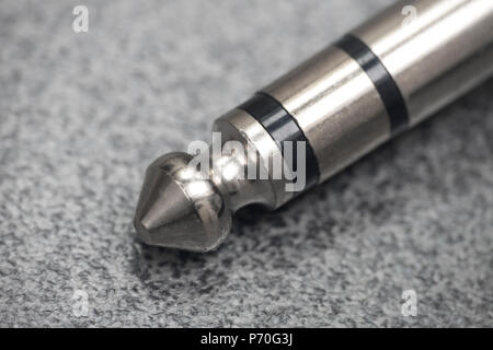 Macro of an audio jack stereo connector on modern table Stock Photo