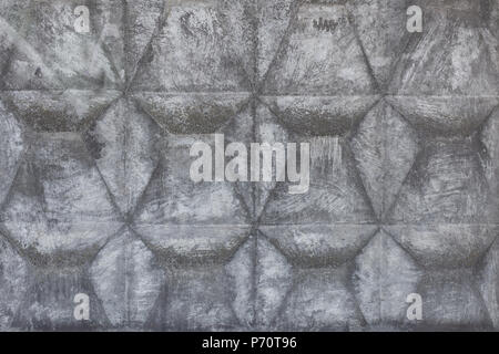 Concrete fence with geometric relief. Grey abstract grunge aged background Stock Photo