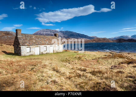 An abandoned cottage on the shores of Loch Stack in Scotland Stock Photo