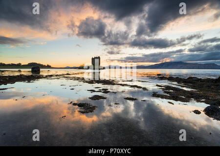 Dramatic sunset over Castle Stalker on Loch Linnhe in Scotland Stock Photo