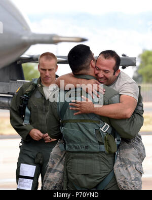 Staff Sgt. Tony Perez, a crew chief assigned to the 149th Fighter Wing, Air National Guard, hugs his co-worker, Tech. Sgt. Vincent Salazar, an avionics specialist, after Salazar’s return from his incentive flight during Coronet Cactus at Davis-Monthan Air Force Base, Ariz., May 9, 2017. Coronet Cactus is an annual training event that takes members of the 149th Fighter Wing, headquartered at Joint Base San Antonio-Lackland, Texas, to Tucson, Arizona to participate in a deployment exercise. (Air National Guard Stock Photo