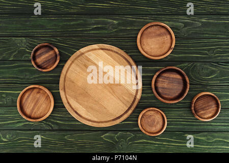 different types of wooden round cutting boards on table Stock Photo