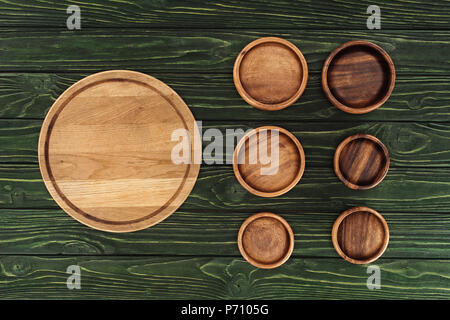 various types of wooden round cutting boards on table Stock Photo