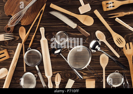 elevated view of different kitchen utensils on wooden table Stock Photo