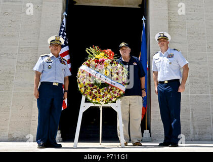 Officer-in-Charge Commodore Joel Garcia, Philippine coast guard, Lt. Cmdr, Jeremy Obenchain ,U.S. Coast Guard, maritime advisor Defense Threat Reduction Agency and U.S. Embassy, and Chief Petty Officer John O’Neil, U.S. Coast Guard Combat Veterans Association,  lay a wreath at the Military American Cemetery chapel, May 9, 2017. The ceremony was culminated with the reveal of  Lt. Crotty’s name now etched on the U.S. Coast Guard wall in the cemetery. Stock Photo