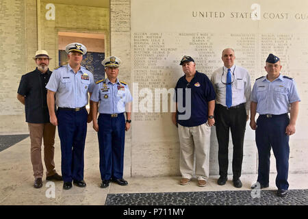 Officer-in-Charge Commodore Joel Garcia, Philippine coast guard, Lt. Cmdr, Jeremy Obenchain ,U.S. Coast Guard, maritime advisor Defense Threat Reduction Agency and U.S. Embassy, and Chief Petty Officer John O’Neil, U.S. Coast Guard Combat Veterans Association,  and other guest stand for a photo at the Military American Cemetery, May 9, 2017. The ceremony was culminated with the reveal of  Lt. Crotty’s name now etched on the U.S. Coast Guard wall in the cemetery. Stock Photo