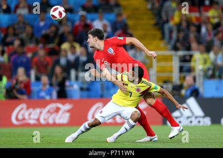 England's Harry Maguire (right) and Colombia's Carlos Bacca battle for the ball during the FIFA World Cup 2018, round of 16 match at the Spartak Stadium, Moscow. Stock Photo