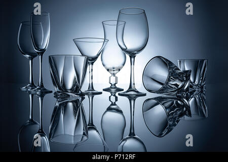 silhouettes of martini, cognac, champagne and wine empty glasses with reflections Stock Photo