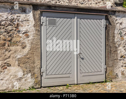A door in the stone wall of an old house in central Europe. Stock Photo