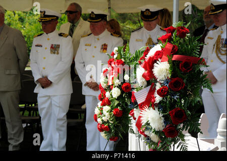 Members of the U.S. Coast Guard, the Royal Canadian Navy, the British Royal Navy and the Friends of the Graveyard of the Atlantic Museum share a moment of silence at the British War Grave Ceremony in Buxton, N.C., on Thursday, May 11, 2017. This is the 75th anniversary of the deaths of British and Canadian sailors from the HMS Bedfordshire and the British merchant vessel San Delfino following their sinking by German submarines in World War II. Stock Photo