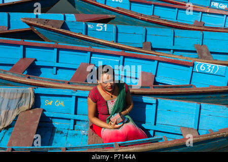 Nepalese woman and boats of Phewa Lake, Pokhara, Nepal, Asia Stock Photo