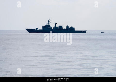 SOUTH CHINA SEA (May 11, 2017) A rigid-hull inflatable boat from Arleigh Burke-class guided-missile destroyer USS Sterett (DDG 104) Royal Thai Navy ship HTMS Naresuan (FFG 421) to conduct a personnel transfer in support of the Cooperation Afloat Readiness and Training (CARAT) multilateral exercise. CARAT is a series of annual maritime exercises aimed at strengthening partnerships and increasing interoperability through bilateral and multilateral engagements ashore and at sea. Stock Photo