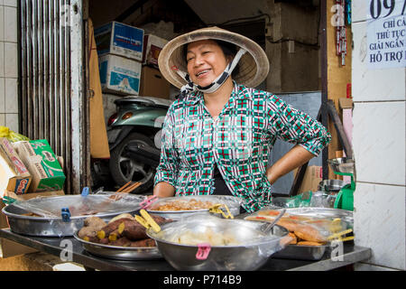 Chinatown street vendor smiling, Ho Chi Minh City, Vietnam, Indochina, Southeast Asia, Asia Stock Photo