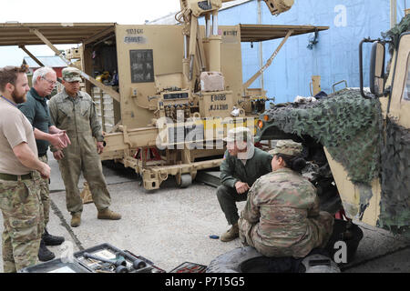 Soldiers of 64th Brigade Support Battalion, 3rd Armored Brigade Combat Team, 4th Infantry Division, conduct maintenance on a vehicle at Dragonkasernen, Denmark, May 11, 2107. The Soldiers are part of the support crew assisting a tank team from the brigade’s 1st Battalion, 66th Armor Regiment, at the Nordic Tank Challenge competition from May 15-18. Stock Photo