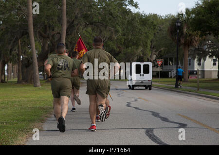 Combat Camera Marines stationed aboard Marine Corps Air Station Beaufort, S.C., and Marine Corps Recruit Depot, Parris Island (MCRD PI), S.C., participate in a 5K memorial run aboard MCRD PI, May 11, 2017. The run was held in memory of Cpl. Sara Medina and Lance Cpl. Jacob Hug, who died May 12, 2015 when a UH-1Y Huey helicopter with Marine Light Attack Helicopter Squadron 469 crashed during Operation Sahayohi Haat, a multinational humanitarian and disaster relief effort, in Nepal. Stock Photo