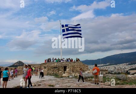 he greek flag flying on a sunny day in athens greece over the acropolis parthenon Stock Photo