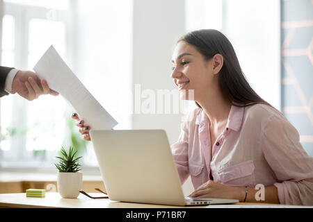Satisfied female intern getting positive feedback from employer Stock Photo