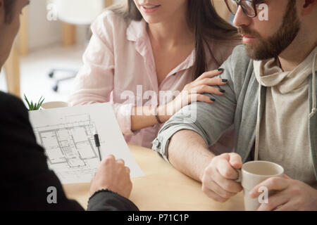 Millennial couple consulting about home design project in archit Stock Photo