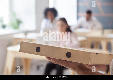 Close up of pizza delivery to multiracial office workers Stock Photo
