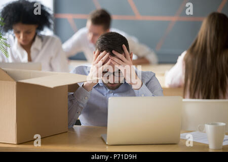 Upset male employee stressed being fired from work Stock Photo