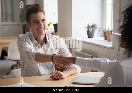 Happy business partners handshaking after successful negotiation Stock Photo