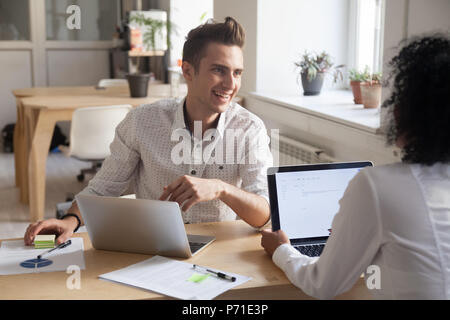 Smiling partners talking brainstorming during office meeting Stock Photo