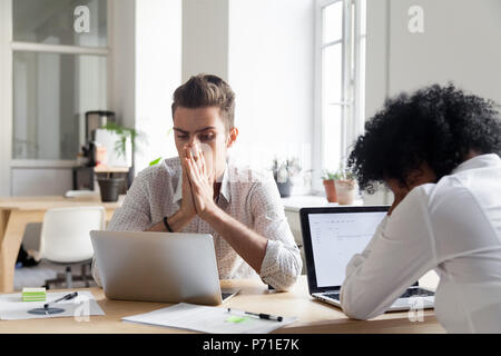 Stressed workers reading company bankruptcy news online Stock Photo