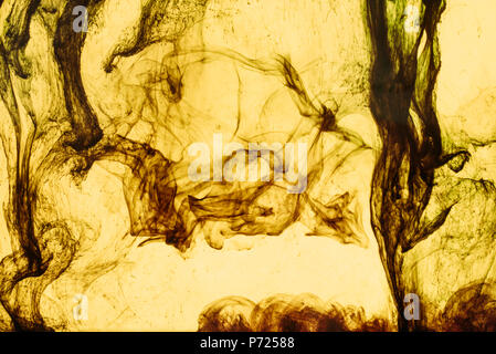 full frame of yellow paint splashes and swirls Stock Photo