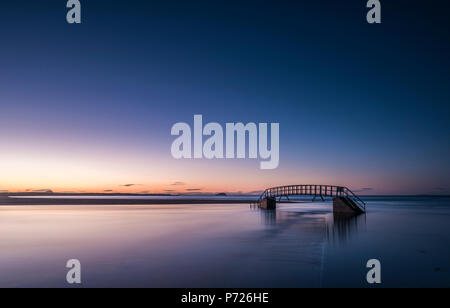 The Bridge To Nowhere, bridge over Biel Water where it flows into Belhaven Bay and the North Sea at Dunbar at sunset, East Lothian, Scotland, UK Stock Photo