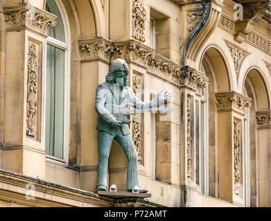 Statue of George Harrison playing a guitar outside Hard Day's Night Hotel, North John Street, Liverpool, England, UK