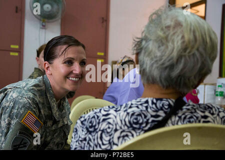 U.S. Army Master Sgt. Jodie Walter provides medical care to local ...