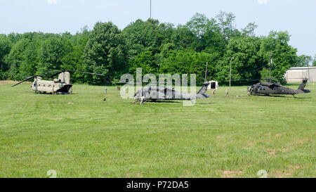 Soldiers from E Company, 6th Battalion, 101st General Support Aviation Battalion, 101st Combat Aviation Brigade, 101st Airborne Division, rush to refuel two UH-60 Black Hawk helicopters as part of a “fat cow” mission, where a CH-47 Chinook helicopter transports fuel to a forward location May 11, 2017, at Fort Campbell, Kentucky. The fat cow mission was in support of Soldiers competing to win the XVIII Airborne Corps’ Philip A. Connelly Program field feeding competition. Stock Photo