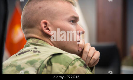 U.S. Army Spc. Justin M. Carter, assigned to 275th Signal Company, 311th Signal Command, participates in the competitors' briefing as a participant of the 2017 Network Enterprise Technology Command (NETCOM) Best Warrior competition at Fort Huachuca, Az., May 11, 2017. The competition is a grueling week-long event that tests the skills, knowledge, and professionalism of 11 Soldiers representing NETCOM's subordinate organizations. Stock Photo