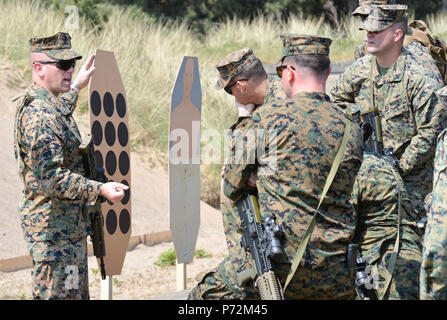 U.S. Marine Corps Capt. Jared Dalton, commanding officer, Marksmanship Training Company, Weapons Training Battalion, instructs Marines about a rifle course of fire at Altcar Training Camp, Hightown, United Kingdom on May 11, 2017. The U.S. Marine Corps travels to the United Kingdom annually to compete in the Royal Marines Operational Shooting Competition and learn with their allies while building relationships. Stock Photo