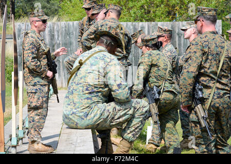 U.S. Marine Corps Capt. Jared Dalton, commanding officer, Marksmanship Training Company, Weapons Training Battalion, instructs Marines about a rifle course of fire at Altcar Training Camp, Hightown, United Kingdom on May 11, 2017. The U.S. Marine Corps travels to the United Kingdom annually to compete in the Royal Marines Operational Shooting Competition and learn with their allies while building relationships. Stock Photo