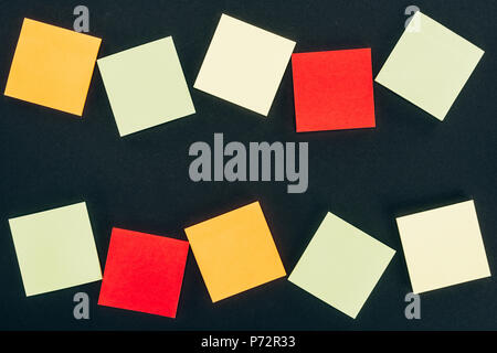 top view of various colorful blank notes on black Stock Photo