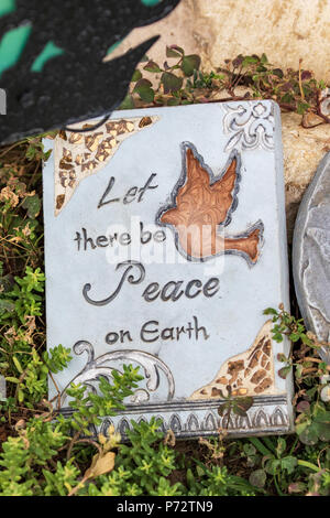 Whimsical Garden Art Decoration - Inspirational Words  - Let There Be Peace On Earth Stock Photo