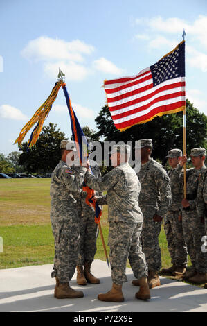 Lt. Col. James E. Ward (right, center), relinquishes command of the 1st Battalion, 145th Aviation Regiment by passing the unit’s color to Col. Brian D. Bennett (right), commander of 1st Aviation Brigade, at Howze Parade Field, Fort Rucker, Ala. during a change of command ceremony. Stock Photo
