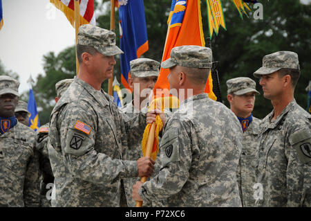 Col. Shawn Prickett (left), accepts the 1st Aviation Brigade colors from Maj. Gen. Kevin W. Mangum during the unit’s change of command ceremony June 14, 2013 at Howze Field, Fort Rucker, Ala.  Prickett, a native of Morgantown, W.V., now commands the “Golden Hawks” brigade, the unit responsible for the training of Army Aviators. Stock Photo