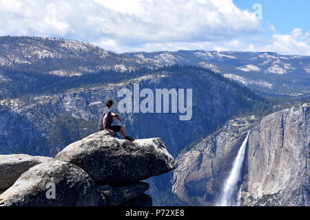 Sitting on top of Glacier Point in Yosemite National Park, California