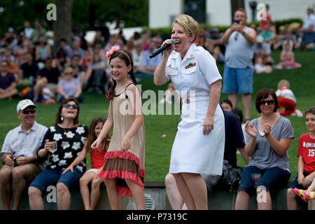 DALLAS (May 11, 2014) Musician 1st Class Shana Sullivan dances with an audience member during a U.S. Navy Band Cruisers concert at the Dallas Arboretum and Botanical Garden. The U.S. Navy Band, based in Washington, is currently on a 12-day tour of Texas. Stock Photo