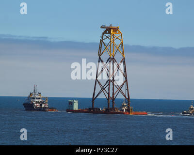 Newcastle Upon Tyne, 4th July 2018, Uk weather. Offshore subsea steel wind turbine foundation jacket (Legs)  been towes into the north sea at Tynesmouth, North Tyneside, Uk. Stock Photo