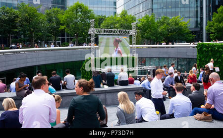 London, England. 4th July 2018. Tourists and office workers watch the tennis at Wimbledon on a giant screen on another very hot day. The present heatwave is set to continue. ©Tim Ring/Alamy Live News Stock Photo