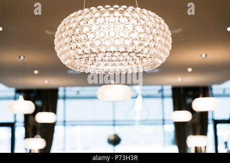 Brightly Lit Round Ceiling Lighting in Restaurant with Blurred Background Stock Photo