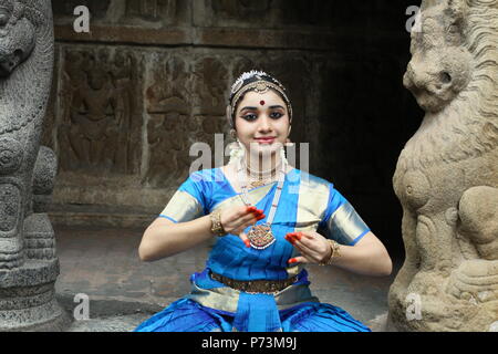 bharatha natyam,one of the eight classical dance forms of india,is from the state of tamil nadu.dancer poses before temples with sculptures Stock Photo