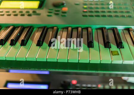 Keyboard of synthesizer in detail in tinted green Stock Photo