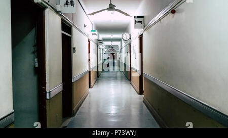 Empty long corridor in the hospital, at the end of the corridor you can read that it says: surgical center. Stock Photo