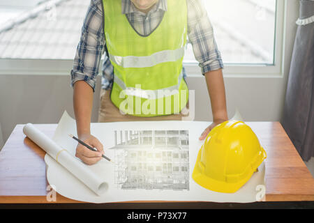 Architect working on blueprint. Architects workplace, Architectural project, Construction concept, Engineering tools Stock Photo