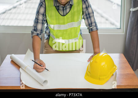 Architect working on blueprint. Architects workplace, Architectural project, Construction concept, Engineering tools Stock Photo