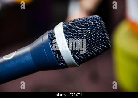 Microphone on abstract blurred of speech in seminar room or speaking conference hall light, Event Background Stock Photo